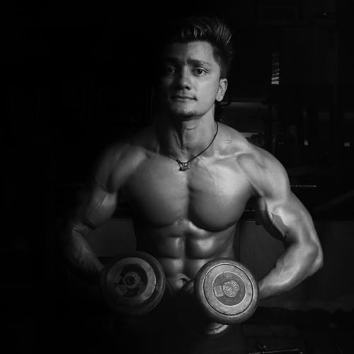 Een man houdt dumbbells vast